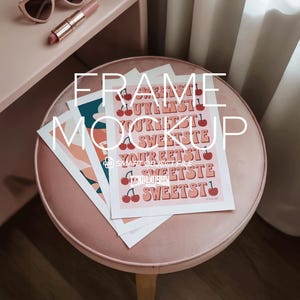 May include: A frame mockup featuring three art prints on a pink velvet stool. One print has the text "SWEETEST" with cherry illustrations. Sunglasses and lipstick are on a nearby surface. The overall aesthetic is soft and feminine.