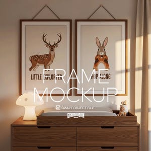 May include: A nursery setting with two framed art prints, each with an animal illustration. One print features a deer with the text "Little Explorer", the other a rabbit with "Hop Along". A mushroom lamp and a wooden dresser are in the foreground.