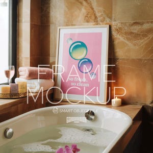 May include: A framed print with a pink background and colourful bubble graphics, with the text "so fresh, so clean." The frame is displayed near a bathtub with water, towels, and a candle, suggesting a spa or bathroom theme.