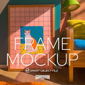 May include: A wooden frame mockup with a pink and blue geometric pattern and a cat illustration. The text "FRAME MOCKUP" is written in white letters on the frame. The frame is sitting on a wooden floor with a fuzzy orange rug in the foreground.