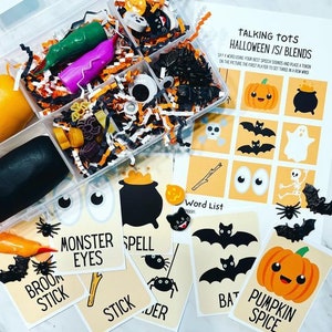 May include: A set of Halloween themed play dough tools and cards for kids. The cards feature words like "monster eyes", "spell", "broom stick", "stick", "bat", and "pumpkin spice". The play dough tools include a cauldron, a pumpkin, a bat, a spider, and a skeleton.