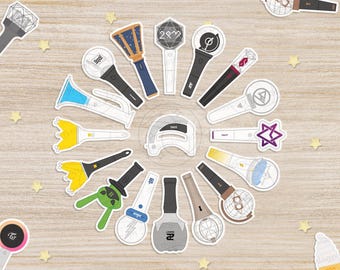 May include: A collection of various K-pop lightstick stickers arranged in a circular pattern. The stickers feature diverse designs including geometric shapes, star motifs, and unique handles in colours like yellow, green, blue, black, and white.