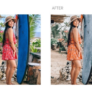 May include: A woman wearing a floral dress and a straw hat stands next to a blue surfboard. She is smiling and looking at the camera. The background is a tropical beach with palm trees.
