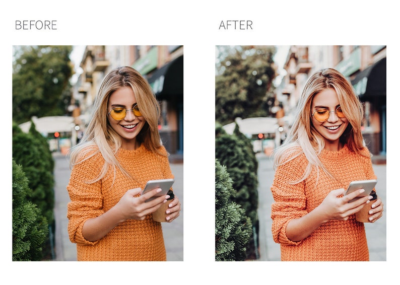 May include: A woman wearing a bright orange sweater and yellow sunglasses is looking at her phone while holding a cup of coffee. She is standing on a city street with trees and buildings in the background.