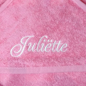 May include: Pink hooded towel with the name "Juliette" embroidered in white. The towel has a white label with the word "Summer" on it.