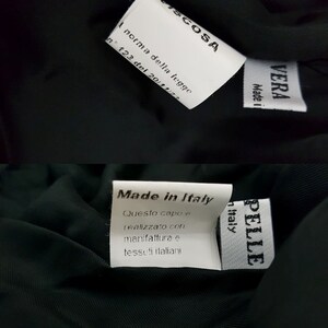 K&ouml;nnte beinhalten: Ein schwarz-wei&szlig;es Etikett mit dem Text "Made in Italy" und dem Text "Questo capo e realizzato con manifattura e tessuti italiani" in Italienisch. Das Etikett ist an einem dunkelgr&uuml;nen Stoff befestigt.
