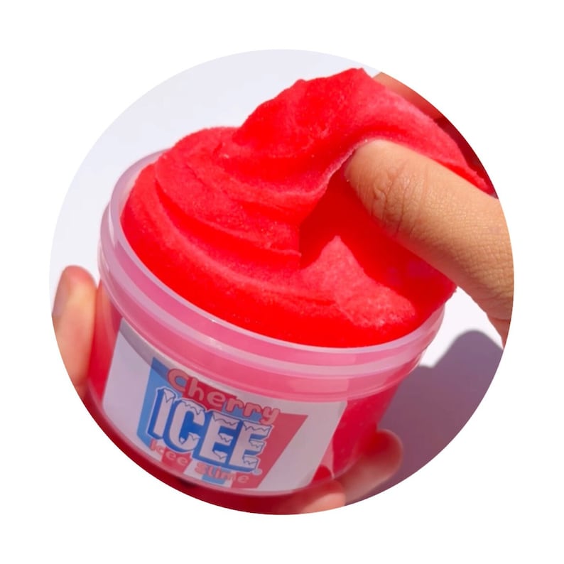May include: A red cherry icee slime in a clear plastic container with a white label that says "Cherry Icee Ice Slime".
