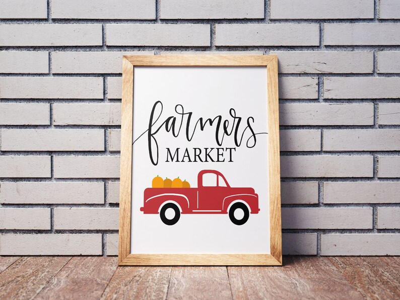 May include: A framed print with a red pickup truck carrying pumpkins and the text "farmers market" in black script.