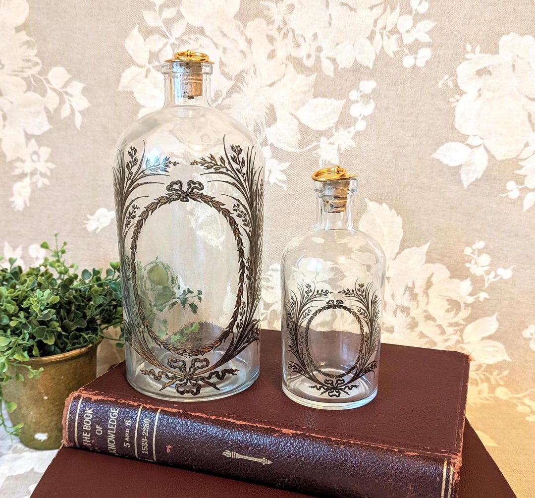 vintage-glass-apothecary-bottle-with-floral-design-and-gold-metal