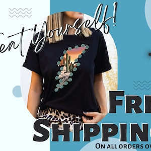 May include: Black t-shirt featuring a desert landscape design within a lightning bolt shape. The design includes cacti, mountains, and a sunset. The words "Treat Yourself!" are written in a script font.