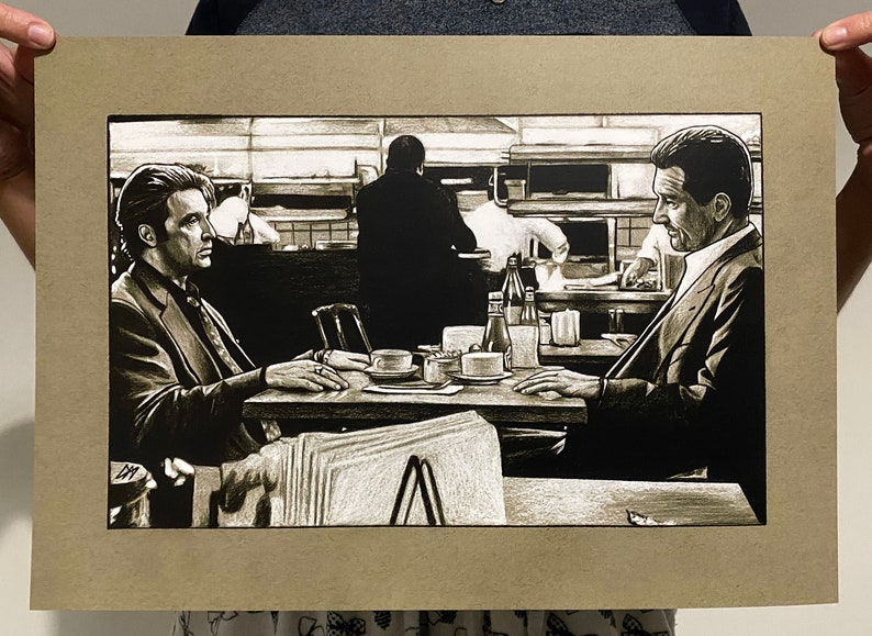 May include: A black and white illustration of two men sitting at a table in a diner. The men are wearing suits and are talking to each other. There are coffee cups and other items on the table.