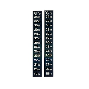 May include: Two black thermometer strips with white markings for Celsius and Fahrenheit temperatures. The strips show temperatures from 18.64 degrees Celsius to 34.93 degrees Celsius and 64 degrees Fahrenheit to 93 degrees Fahrenheit.
