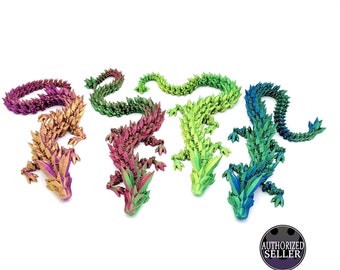 May include: Four origami dragons in different colors: purple, pink, green, and blue. The dragons are made of folded paper and have a scaly texture.