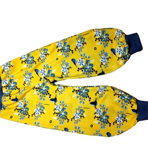 Könnte beinhalten: Gelbe Hose mit blauem Blumenmuster und blauen elastischen Bündchen.