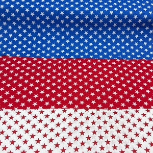 May include: A fabric with a repeating pattern of white stars on a blue background, white stars on a red background, and white stars on a white background.