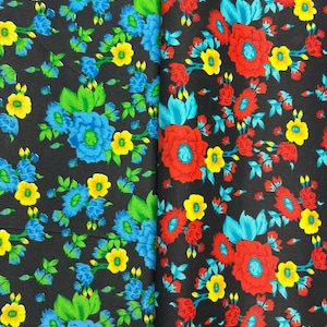 May include: Two fabric swatches with floral patterns. The left swatch has blue, yellow, and green flowers on a black background. The right swatch has red, yellow, and blue flowers on a black background.