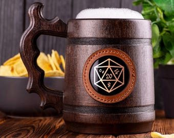 May include: A dark brown wooden beer stein with a leather patch featuring a gold 20-sided die. The stein is filled with a white foamy liquid.