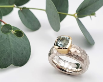 Silver ring with aquamarine in gold setting