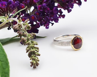 Silver ring with rhodolite in gold setting