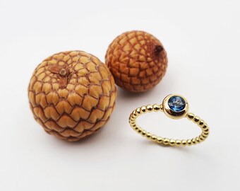 Gold bead ring with topaz
