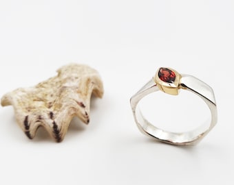 Anillo de diseño fabricado en plata con granate en dorado engastado