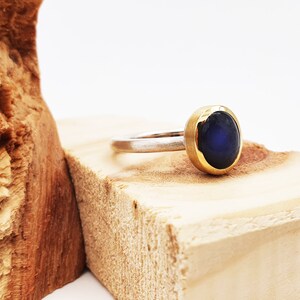 Silver ring with labradorite in gold setting image 3