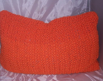 Pillow orange stuffed from textile yarn knitted