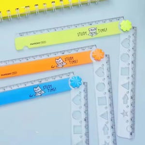 May include: Three folding rulers in neon yellow, orange, and blue, each featuring a cartoon animal illustration and the text "STUDY TIME!". The rulers have a flower-shaped hinge and a clear plastic extension with various geometric cutouts.