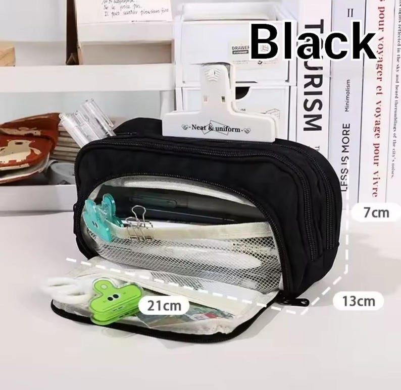 May include: A black rectangular pencil case with multiple zippered compartments and a clear mesh front panel. The case features a white clip labeled Neat & uniform on top. Dimensions are clearly marked as 21 inches by 13 inches by 7 inches.