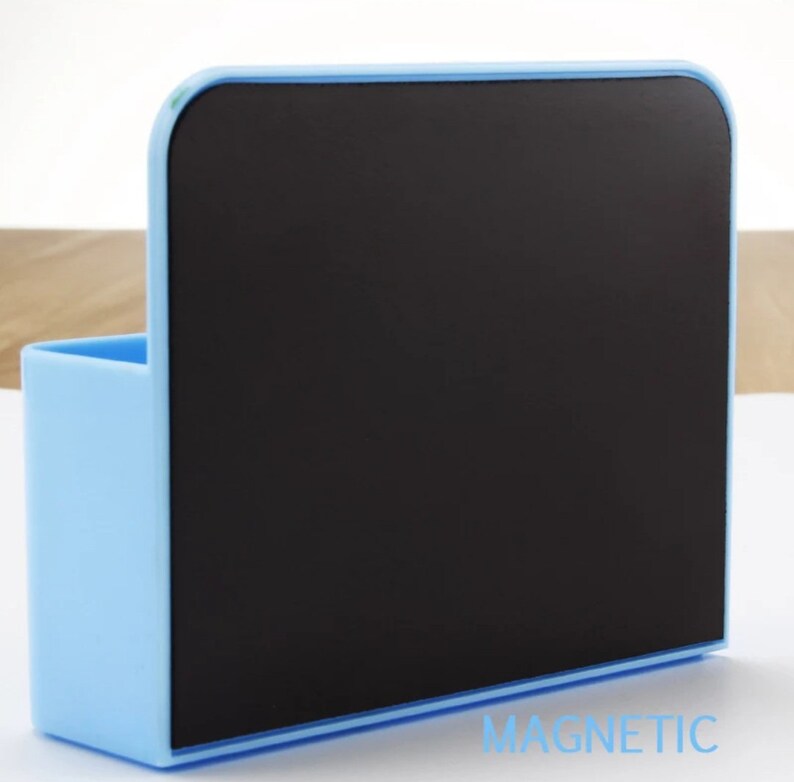 May include: A light blue magnetic memo board with a black writing surface and a small pen holder. The word "MAGNETIC" is printed in light blue at the bottom right corner.