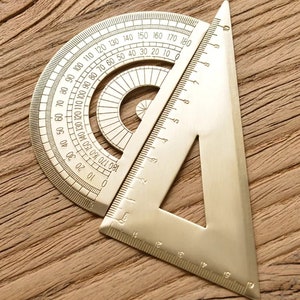May include: A gold-toned protractor and a triangle ruler. The protractor has markings from 0 to 180 degrees. The triangle ruler has markings in centimeters.
