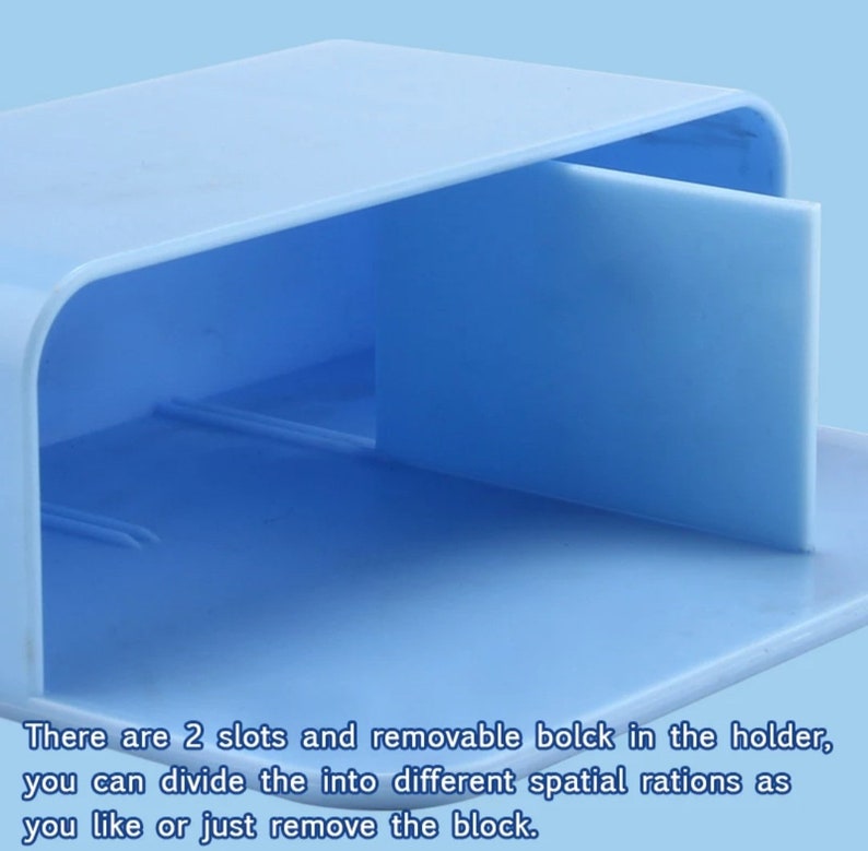 May include: A light blue plastic organizer with a removable divider. The organizer has two slots and a flat base. The text on the image says, "There are 2 slots and removable block in the holder, you can divide the into different spatial rations as you like or just remove the block."