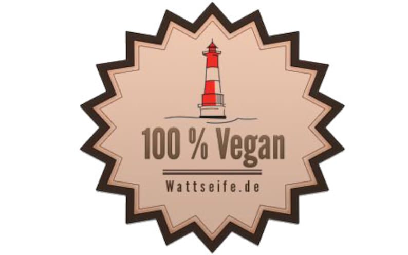 Puede incluir: Una pegatina marr&oacute;n en forma de estrella con una ilustraci&oacute;n de un faro y el texto "100% Vegan" y "Wattseife.de".
