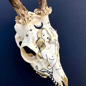 Antique hand-painted deer skull with woman and snake motif
