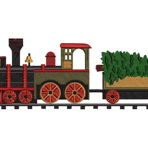 May include: A black and red toy train engine pulling a boxcar with a green Christmas tree inside. The train is on a track with a white background.