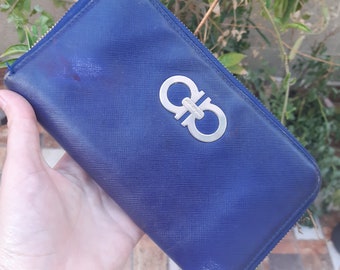 May include: A blue leather wallet with a silver double-G logo.