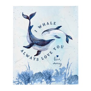 May include: A soft, light blue blanket featuring a watercolor illustration of two whales. The larger whale is dark blue, and the smaller whale is white and blue. Text reads "I whale always love you, love, macy."