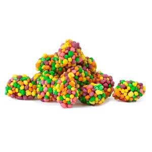 May include: A pile of colorful, round candies in shades of green, yellow, orange, pink, and purple. The candies are clustered together, resembling small, textured clusters. The background is plain white.