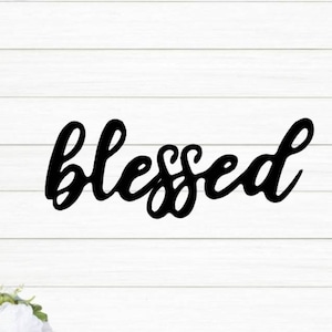 May include: Black metal wall decor with the word "blessed" written in a cursive font.