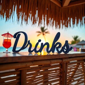 May include: A wooden sign that spells out "Drinks" in a dark blue color, with a cocktail and a red umbrella. The sign is on a wooden bar with a tropical beach scene in the background.