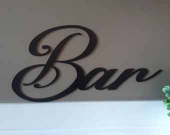 May include: Black metal wall decor with the word "Bar" in a cursive font.