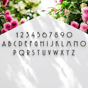 May include: A white background with black text showing the alphabet and numbers in a modern font. The letters are uppercase and the numbers are in a single row.