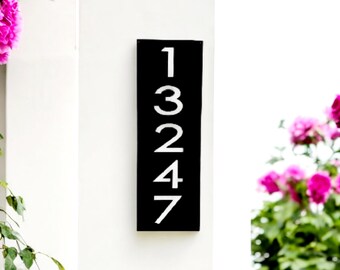 May include: Black house number sign with white numbers 13247.