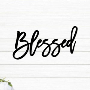 May include: Black metal wall decor with the word "Blessed" written in a cursive font.