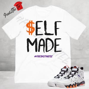 May include: White t-shirt with black text that reads "$ELF MADE" and the hashtag "#FRESH2THATEE". A pair of white, black, and orange sneakers are in the bottom right corner of the image.