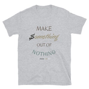 May include: Gray short-sleeved t-shirt with the text "MAKE something OUT OF NOTHING" and the words "FRESH THINK TEE" in smaller font below.