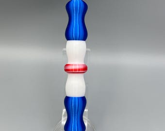 May include: A blue, white, and red diamond painting tool with a white handle and a blue tip. The tool is designed to pick up and place diamonds for diamond painting.
