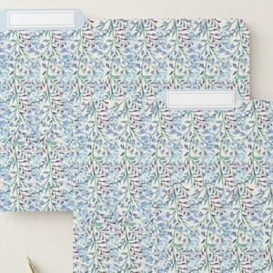 May include: A set of three ceramic mugs with a speckled, matte finish. The mugs are in shades of cream, light gray, and dark gray. Each mug has a simple, modern design and a rounded handle. The mugs are stacked on top of each other.