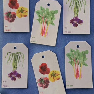 May include: Set of six gift tags with watercolor illustrations of vegetables. The tags feature images of tomatoes, onions, and chard. Each tag has the words "TO" and "FROM" printed in red.