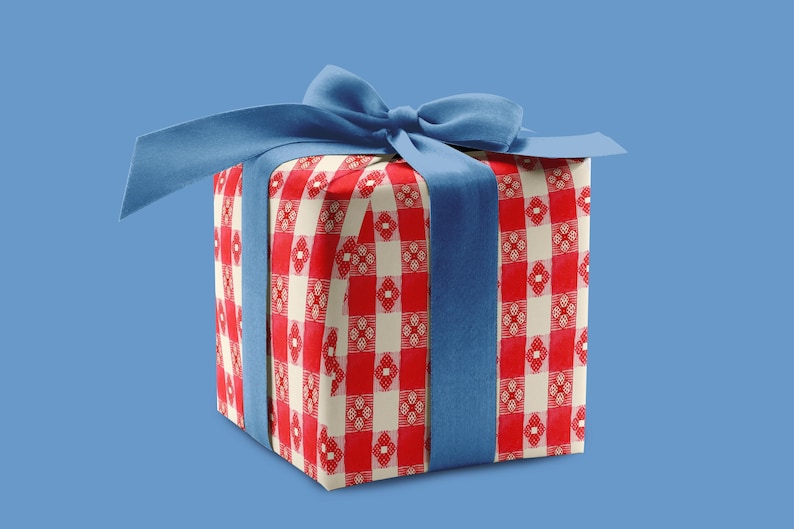 May include: A square gift box wrapped in red and white checkered paper, tied with a blue satin ribbon and bow. The gift is presented against a solid blue background, creating a visually appealing contrast.